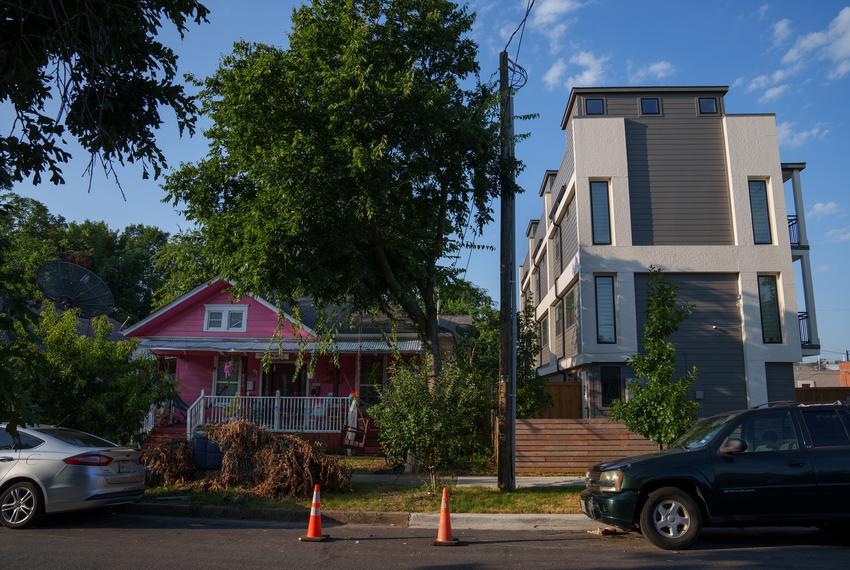 Newly developed apartments sit next to older homes in the Oak Cliff neighborhood of Dallas on July 11, 2024.